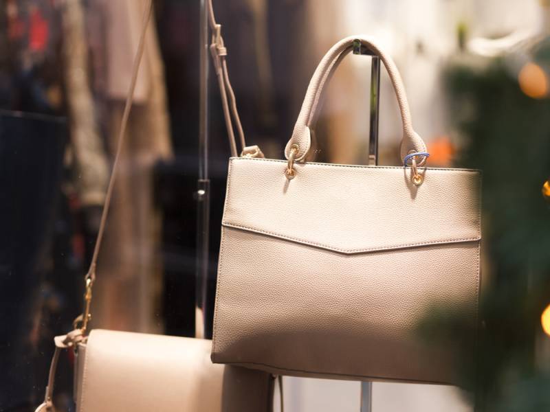 Showcase with women's handbags. Women's clothing store. Shopping	
